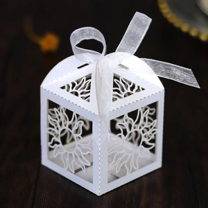 Close-up of white laser-cut sunflower candy box with elegant organza ribbon bow