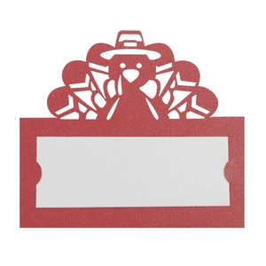 Macro detail of laser-cut red turkey place card with white writing area for table setting
