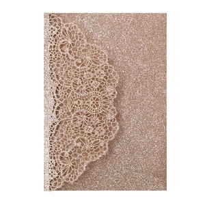 Macro detail of rose gold glitter laser-cut lace wedding invitation card cover
