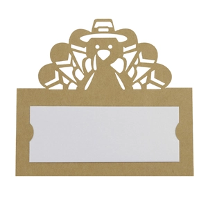 Detail of laser-cut turkey place card made of brown kraft paper and white insert