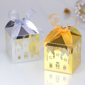 Detailed laser-cut castle candy boxes in gold and silver with elegant silk ribbons