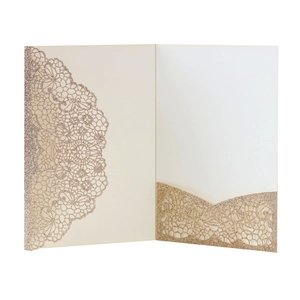 Close-up of laser-cut lace champagne gold glitter card invitation with inner pocket