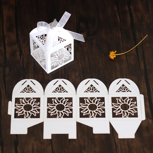 Macro view of white sunburst laser-cut candy box with ribbon and flat template