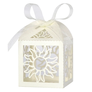 Detail of laser-cut sun pattern on white pearlescent paper gift box with organza ribbon