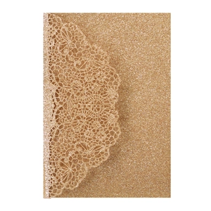 Detailed laser-cut lace pattern on shimmering gold glitter paper wedding invitation card