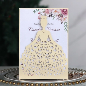 Detail of laser-cut bridal silhouette invitation with lace texture and pink floral insert