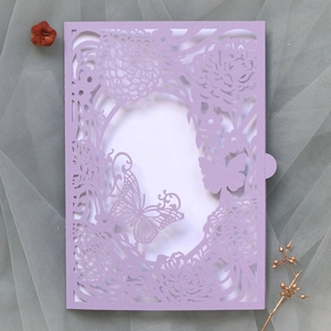 Detailed laser-cut purple butterfly and floral pattern on elegant wedding invitation paper