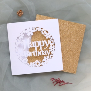 Detail of laser-cut Happy Birthday card with glitter gold insert and floral pattern