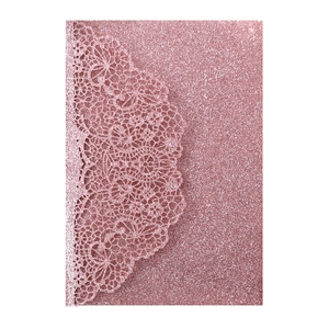 Detailed close-up of pink glitter cardstock featuring intricate laser-cut lace floral pattern