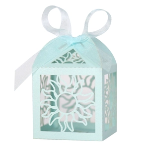 Macro detail of laser-cut sunburst pattern and blue ribbon on light blue gift box