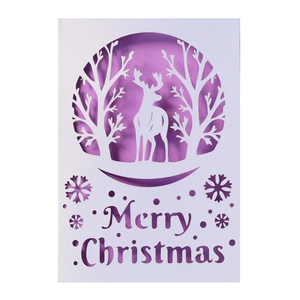 3D laser cut Christmas greeting card featuring white reindeer, trees and purple background