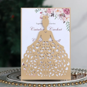 Detailed laser-cut wedding invitation featuring a golden gown silhouette and floral card