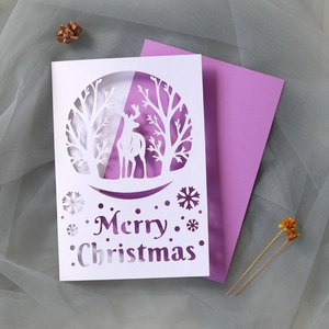 Detailed laser-cut white Christmas card with elk forest motif and purple envelope