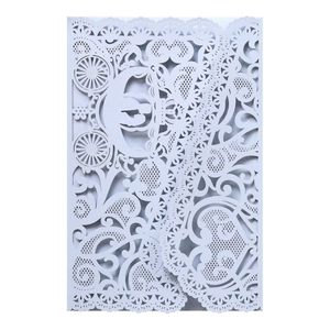 Detailed laser-cut wedding invitation featuring an elegant white pumpkin carriage design