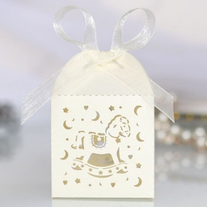 Detail of laser-cut rocking horse gift box in cream white with a soft organza ribbon