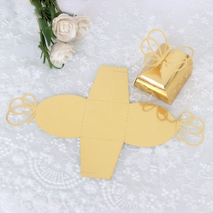 Detailed view of golden laser-cut butterfly candy box with reflective mirror surface