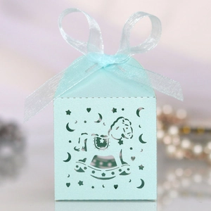 Detail of light blue laser-cut rocking horse candy box with stars and ribbon bow
