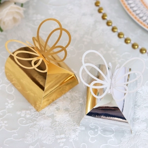 Detail of laser-cut 3D butterfly candy boxes with reflective gold and silver finish
