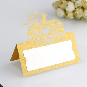 Detailed laser-cut pumpkin place card with gold glitter finish for Halloween table decor