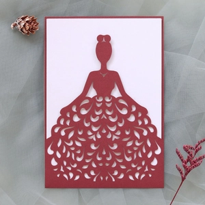 Detail of laser-cut wedding invitation featuring an elegant female silhouette dress