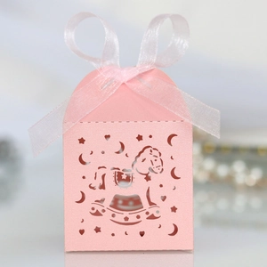 Pink laser-cut rocking horse favor box with a white organza ribbon bow for baby showers