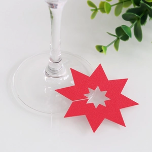 Detail van rode stervormige wijnglaskaart van papier met uitgesneden ster voor feest