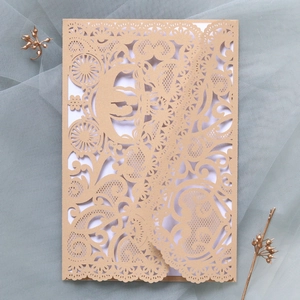 Detailed laser cut pumpkin carriage on champagne gold lace wedding invitation card