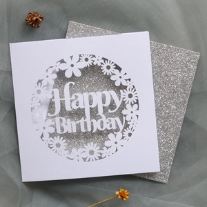 Detailed laser-cut Happy Birthday card featuring silver glitter inlay and daisy patterns