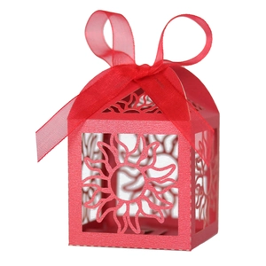 Red hollow sun-pattern paper favor box with elegant ribbon bow for party gifts