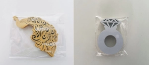 Detail of laser-cut peacock wood craft and diamond ring card in clear plastic packaging