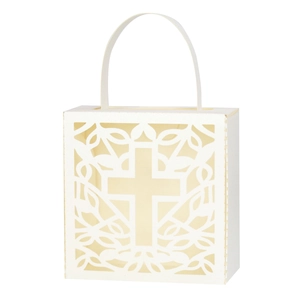 Detail view of laser-cut cross and vine patterns on cream white wedding favor bag