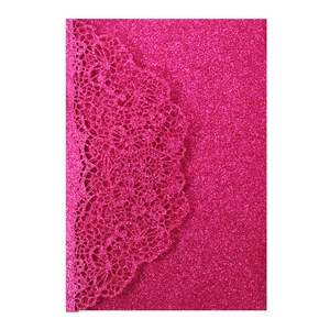 Detail of laser-cut floral pattern on rose red glitter invitation card cover