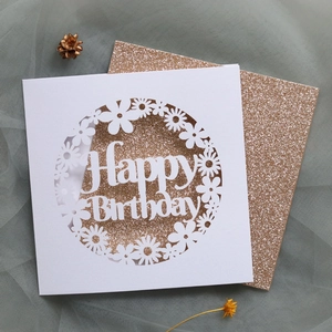Detailed macro view of laser-cut Happy Birthday card with gold glitter inner lining