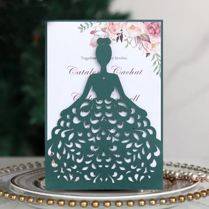 Macro detail of laser-cut wedding invitation showing green cardstock and floral insert