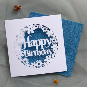Detail of laser-cut Happy Birthday card with glitter blue insert and floral pattern