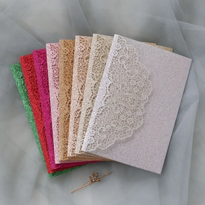 Macro detail of laser-cut floral patterns on glitter paper wedding invitations cards