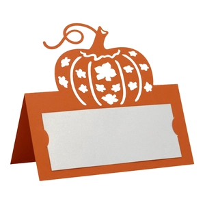 Detail of orange hollow pumpkin place card with laser-cut maple leaf pattern for table