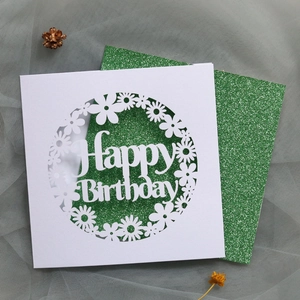 Detail of laser-cut Happy Birthday card with green glitter liner and floral frame