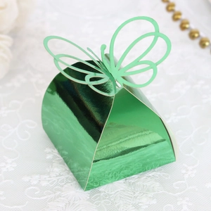 Detail view of laser-cut 3D butterfly candy box in metallic green with hollow design
