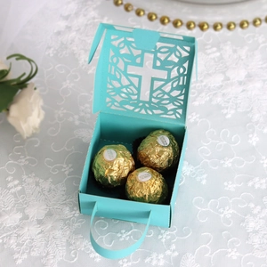 Detailed laser-cut Tiffany blue cross candy box holding three chocolate balls