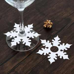 Detailed view of white snowflake wine glass paper cards for winter holiday table decor