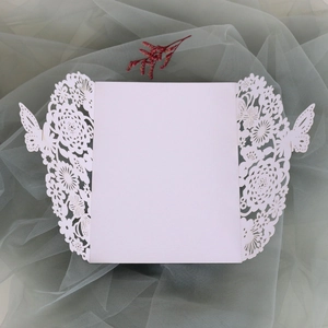 Laser cut butterfly wedding invitation cover with intricate floral hollow design on white paper