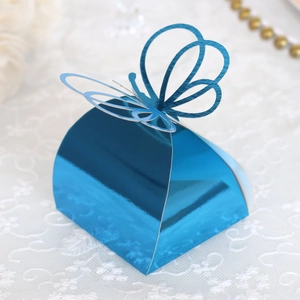 Detail of blue metallic butterfly candy box with laser-cut design on lace background