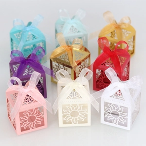 Laser-cut sun pattern gift boxes in various colors with elegant ribbon bows