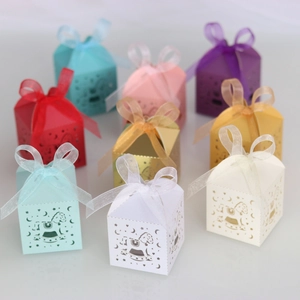 Detailed laser-cut candy boxes with rocking horse patterns and matching silk ribbons