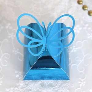 Close-up of laser-cut butterfly candy box in metallic blue with hollow wings design