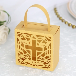 Close-up of glitter gold laser-cut favor box with hollow cross and floral pattern