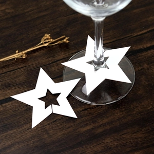 Vista macro de tarjeta para copa en forma de estrella blanca con diseño hueco en madera
