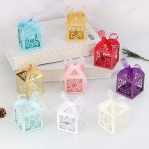 Detailed laser cut sun pattern candy boxes with silk ribbons in various vibrant colors