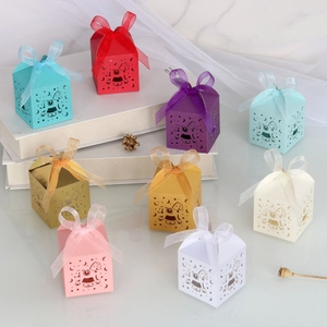 Detailed view of hollowed-out rocking horse gift boxes with satin ribbon in multiple colors